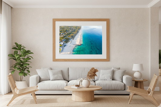 Living room with a large framed picture of a beach on the wall