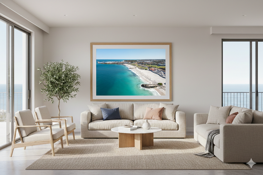 Modern living room with a large framed picture of a beach scene on the wall.