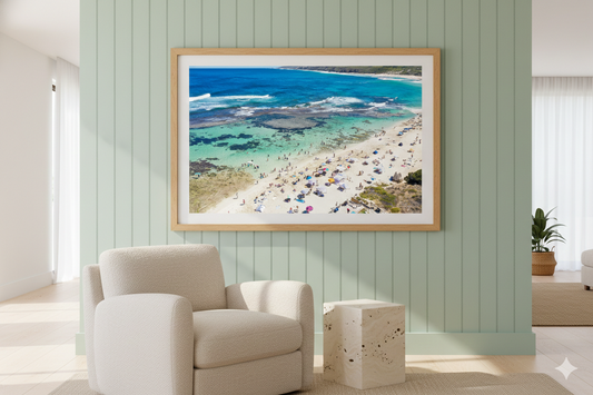 Framed artwork of a beach scene on a wall in a modern living room.