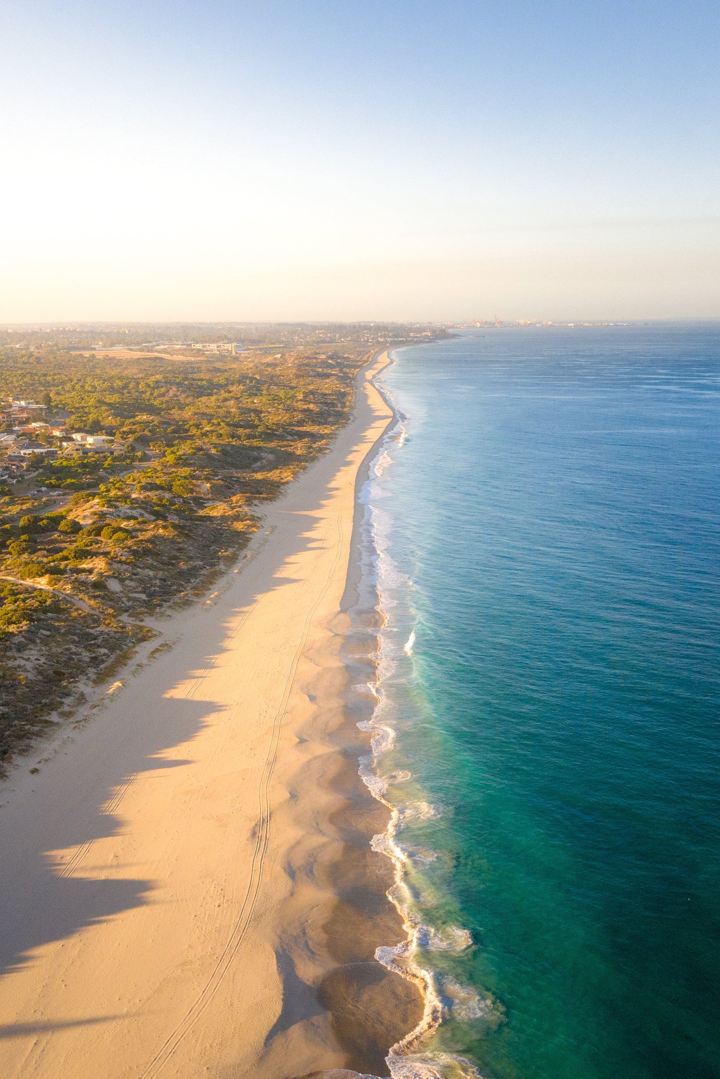 A fine art print featuring a coastal landscape with a sandy beach and ocean in the background.