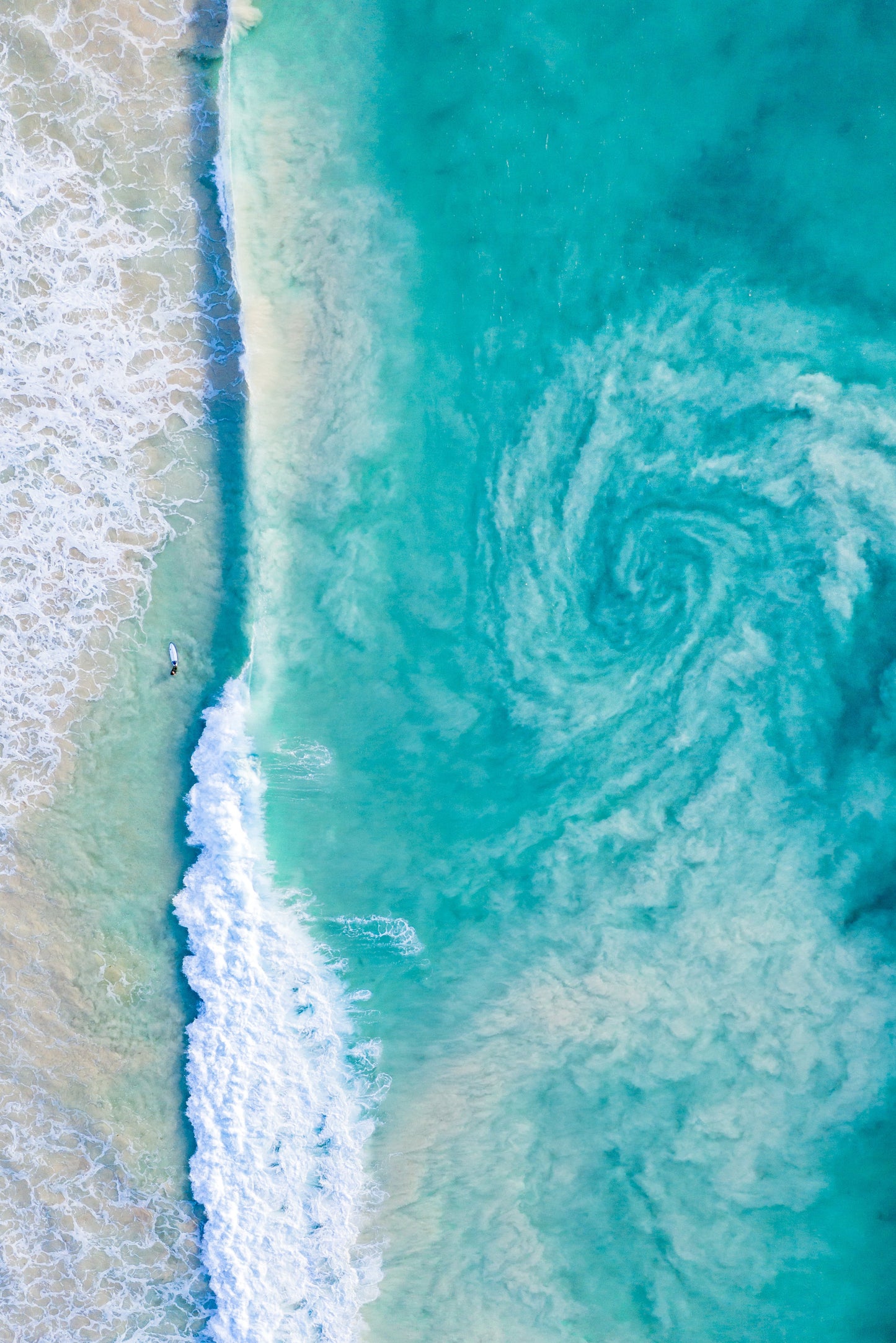 A fine art print featuring an ocean scene with a stormy sea and calm beach.
