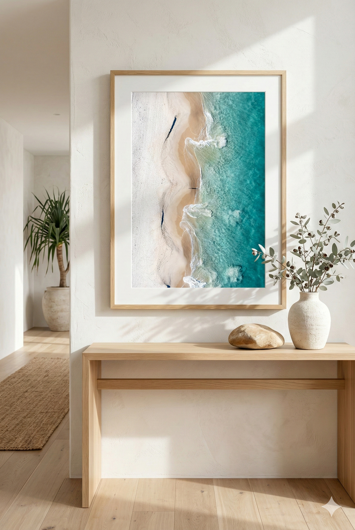 Framed abstract artwork on a wall above a wooden console table with decorative items.