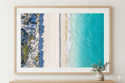 Framed artwork of a beach scene with turquoise water and blue sky.
