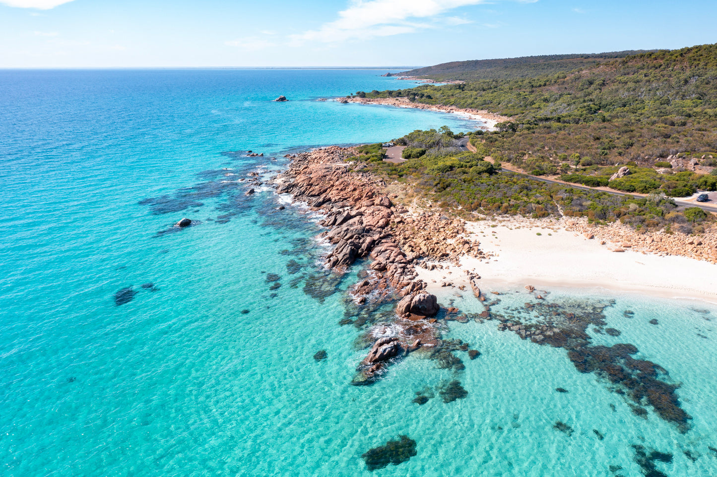 Aerial view of a coastal landscape with clear blue water and rocky shoreline. Eagle Bay WA Framed aerial print.