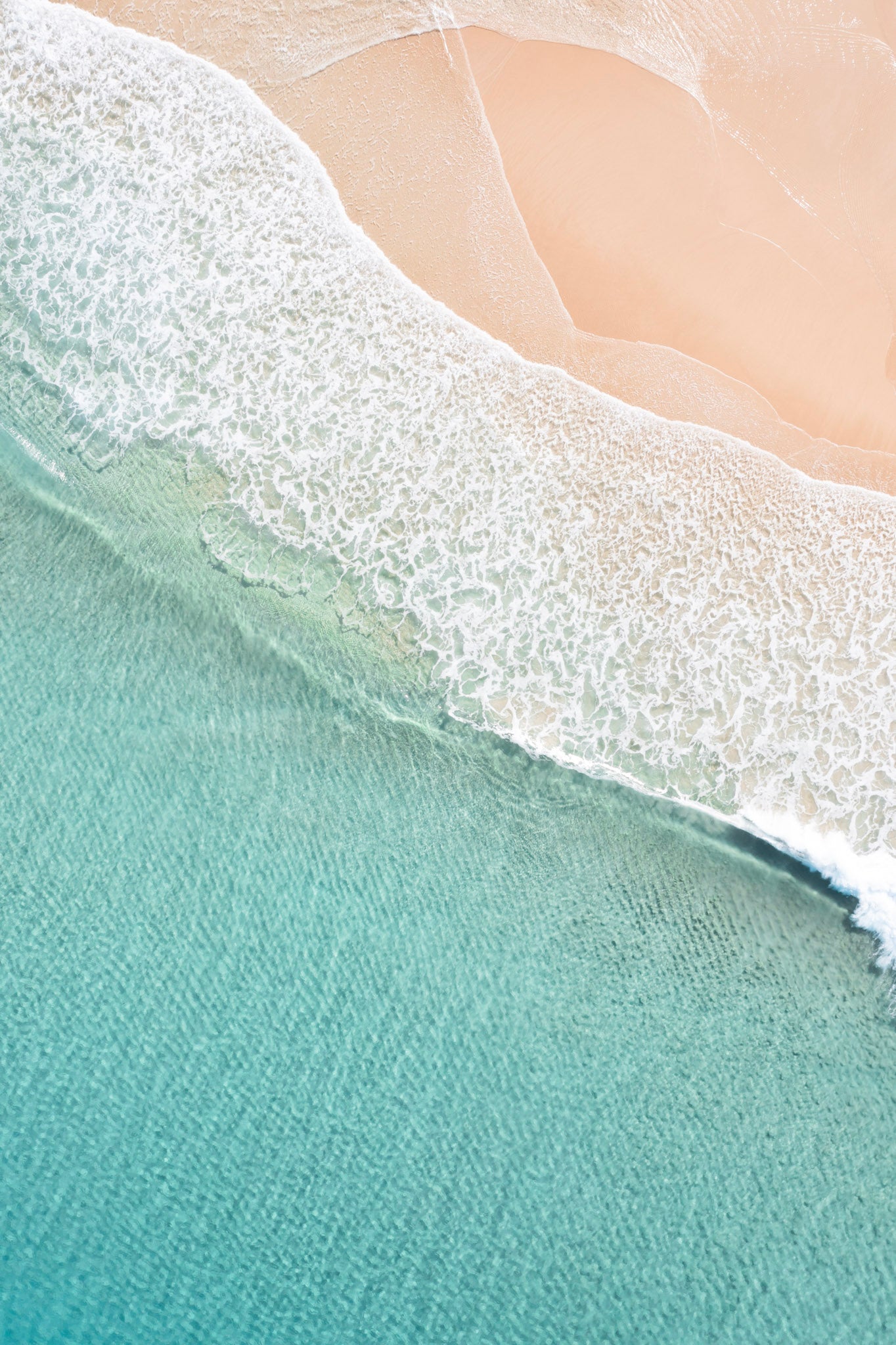 Close-up of waves crashing onto a sandy beach