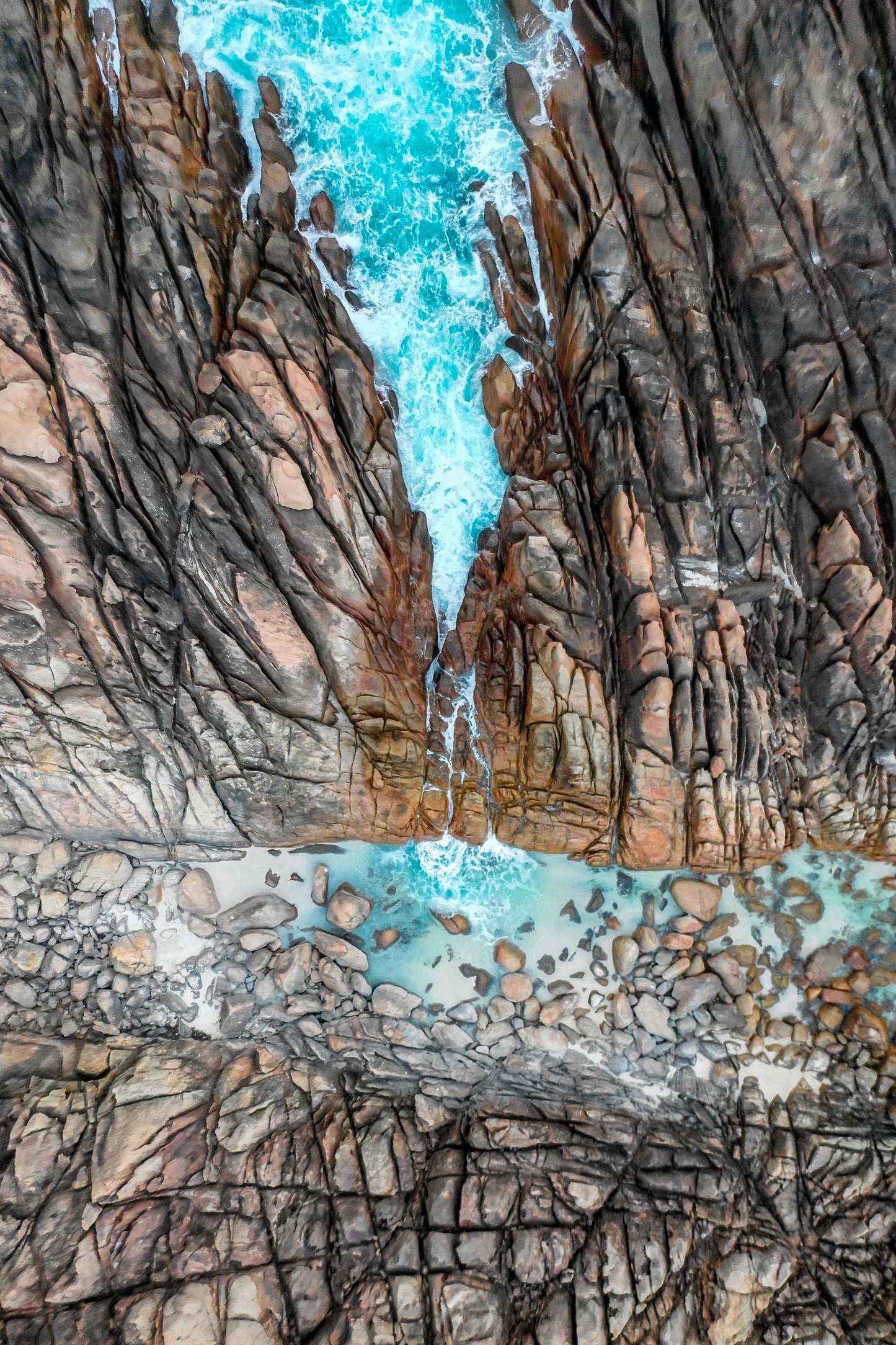 Close-up of rugged rock formations with turquoise water.