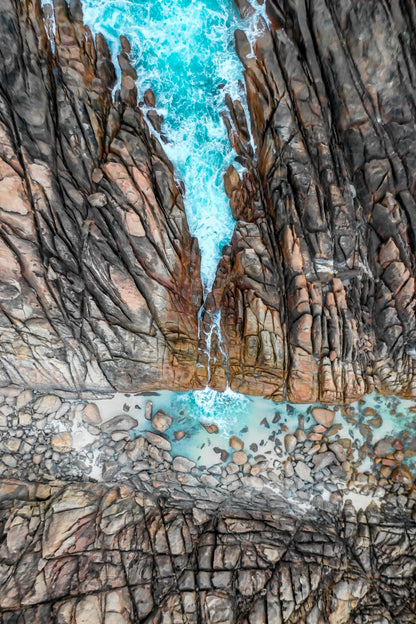 Close-up of rugged rock formations with turquoise water.