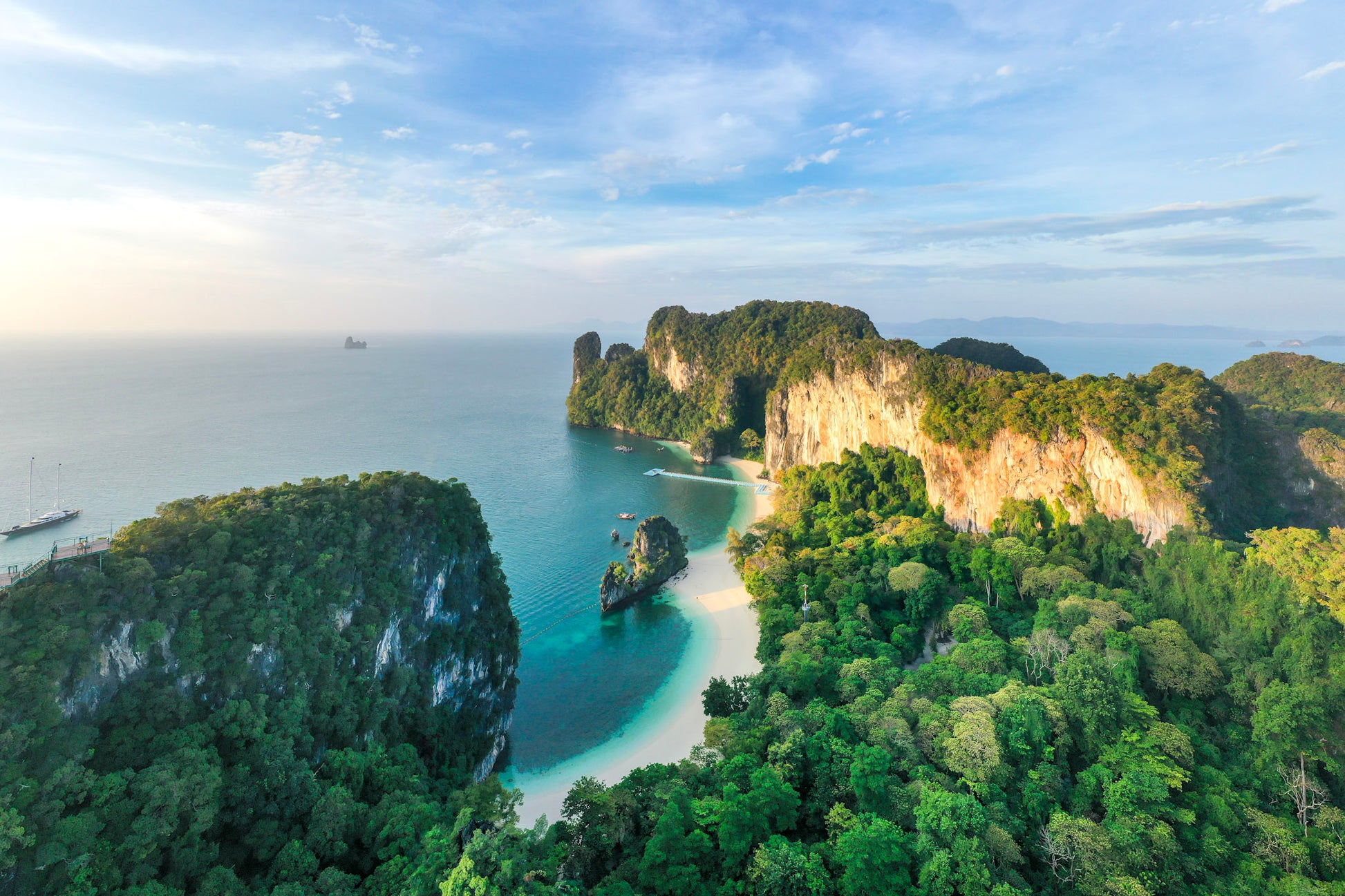 Aerial view of a tropical island with lush greenery and clear blue water.