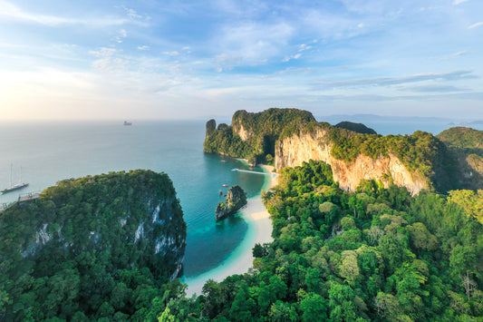 Aerial view of a tropical island with lush greenery and clear blue water.