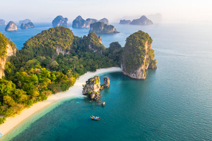 Aerial view of a tropical island with lush greenery and clear blue water.