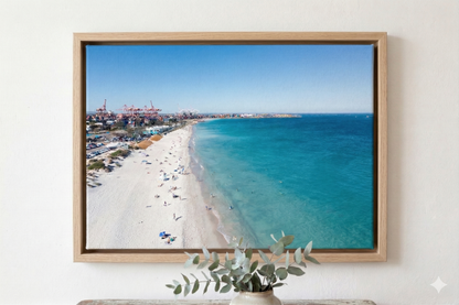 Framed photograph of a beach scene with clear blue sky and ocean.