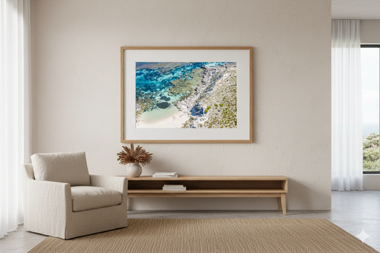 Living room with a framed beach photo on the wall, beige armchair, and wooden coffee table.