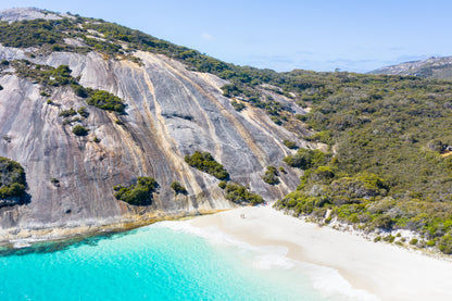 Beach with turquoise water and a rocky hillside