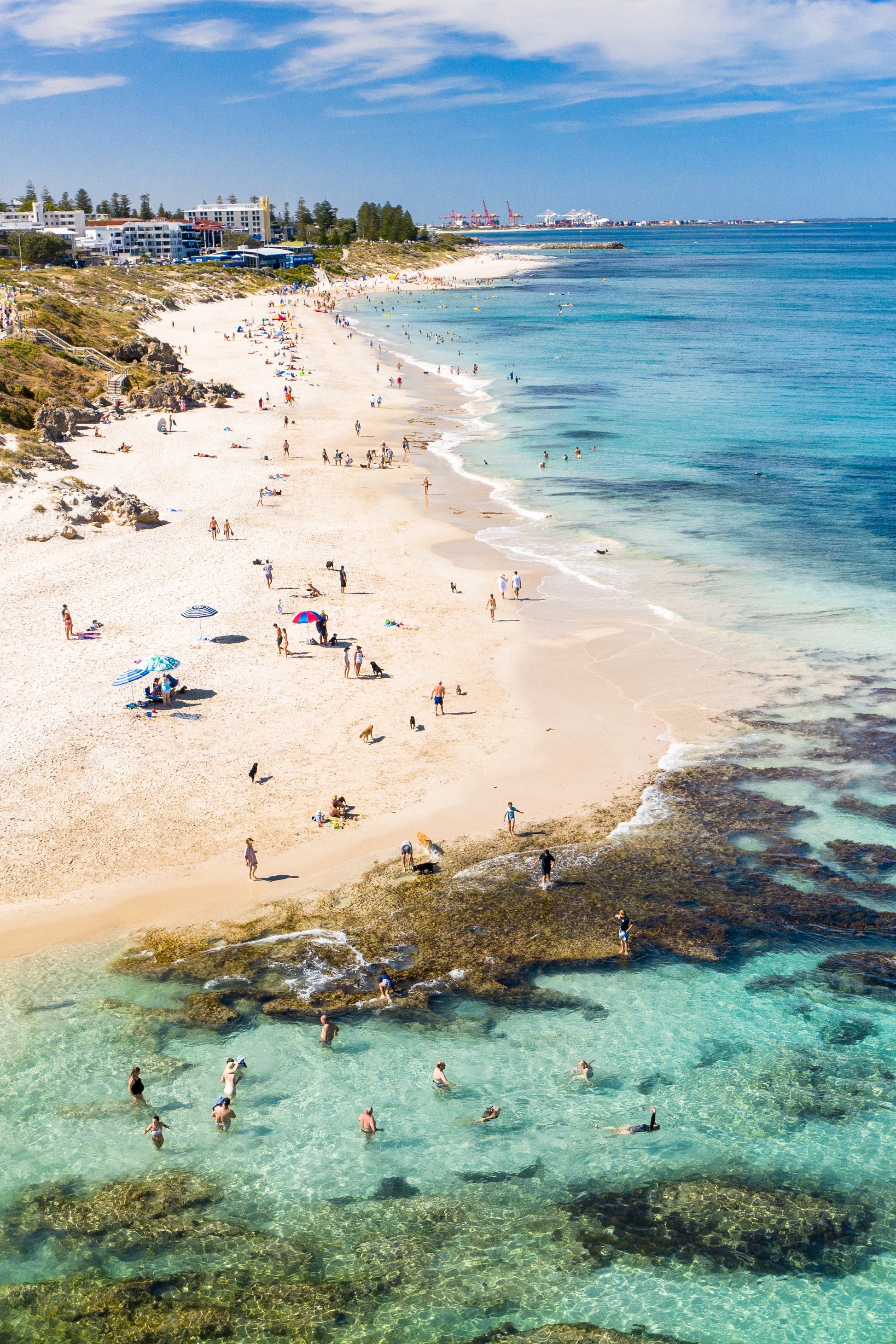 A vibrant fine art print of a beach scene with clear blue water, sandy beach, and a framed picture showing the ocean and beach goers.